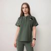 Model wearing an olive button-neck scrub top with stethoscope